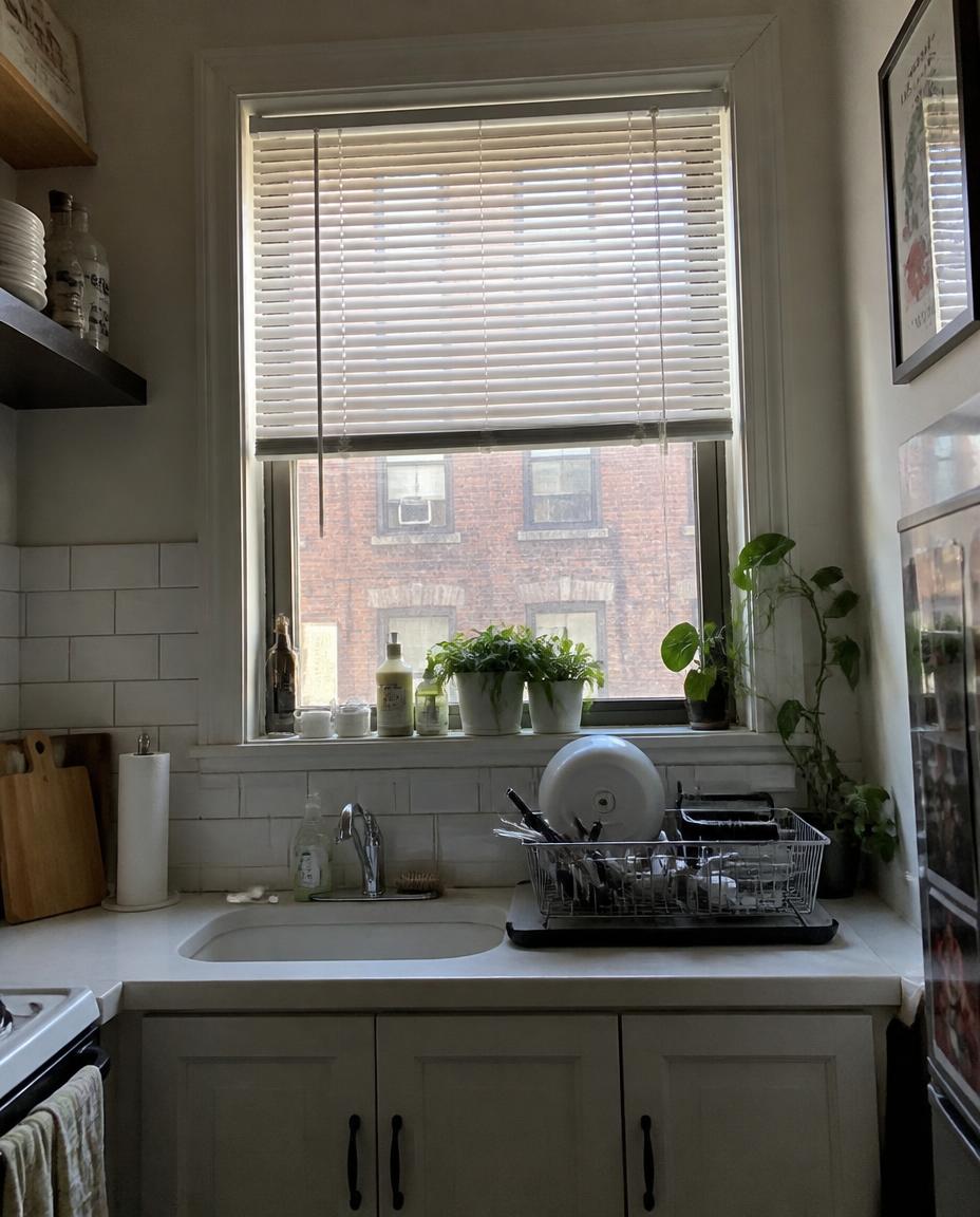 White aluminum mini blinds in a bright New York apartment kitchen